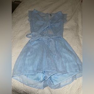 Baby blue romper. Size SMALL, never worn, brand new! Brand is Lucy in the sky!
